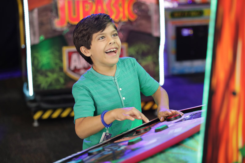 Child playing arcade game